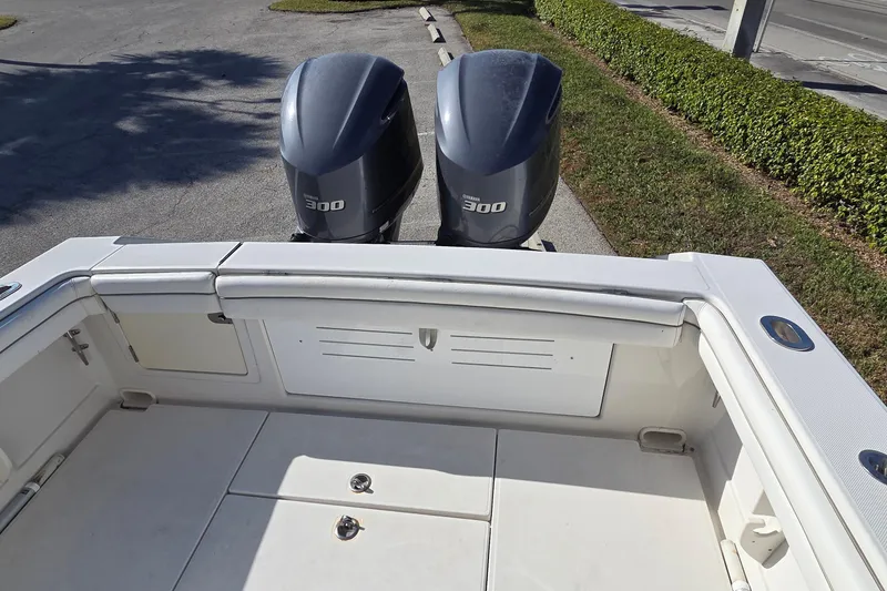 Slide: The Image of 2015 Jupiter 30 FS boat with twin Yamaha 300 engines, docked on a sunny day. - 21