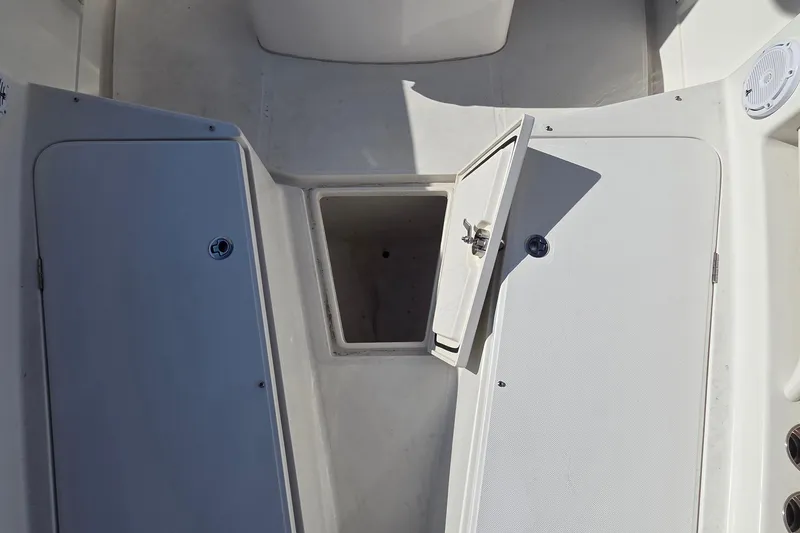 Slide: The Image of 2015 Jupiter 30 FS boat storage compartments with open hatch, showcasing interior space. - 5
