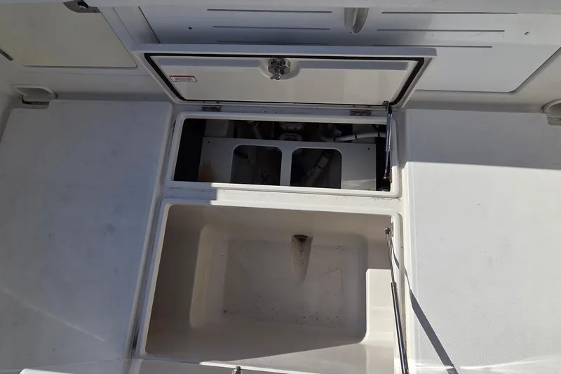 Slide: The Image of 2015 Jupiter 30 FS boat storage compartments, open and empty, showcasing interior space. - 8