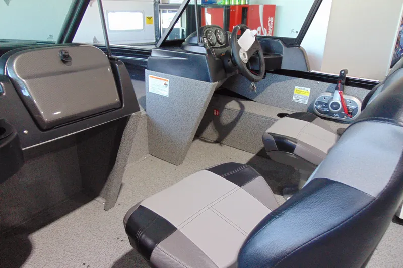 Slide: The Image of 2026 Crestliner 1850 Kodiak WT interior with steering wheel and seating. - 6