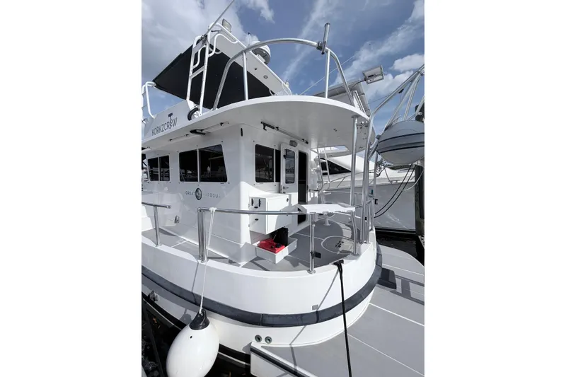 Slide: The Image of 2008 Great Harbour N37 boat docked, featuring a spacious deck and modern design. - 17