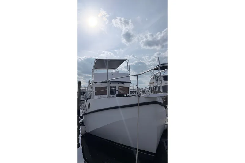 Slide: The Image of 2008 Great Harbour N37 boat docked under a cloudy sky. - 18