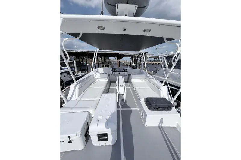 Slide: The Image of 2008 Great Harbour N37 boat deck with seating and storage, docked under a cloudy sky. - 19