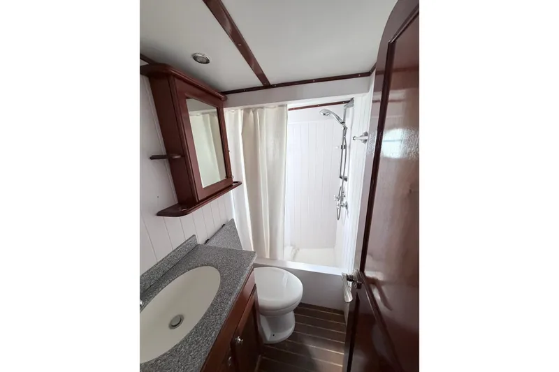 Slide: The Image of Bathroom interior of 2008 Great Harbour N37 yacht with shower, sink, and wooden cabinetry. - 27