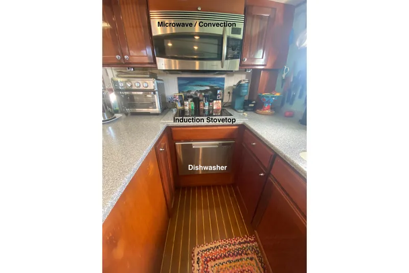 Slide: The Image of 2008 Great Harbour N37 kitchen with microwave, induction stovetop, and dishwasher. - 4