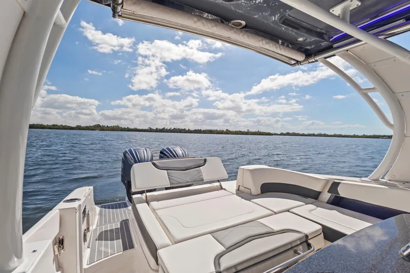 Slide: The Image of 2022 Chaparral 300 OSX boat interior with scenic water view and clear sky. - 10