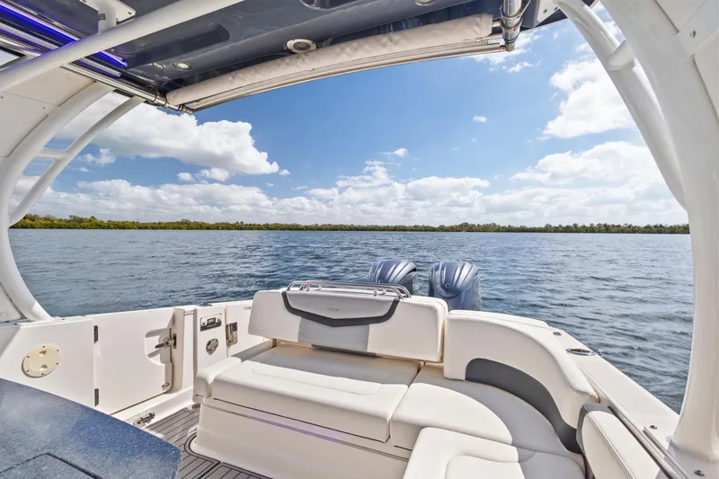 Slide: The Image of 2022 Chaparral 300 OSX boat interior with scenic water view and clear sky. - 12
