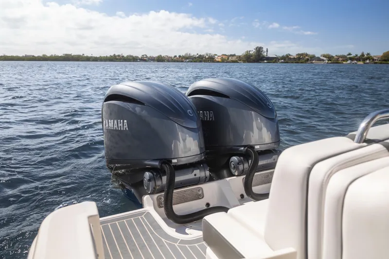 Slide: The Image of 2022 Chaparral 300 OSX with twin Yamaha outboard engines on a sunny day. - 13
