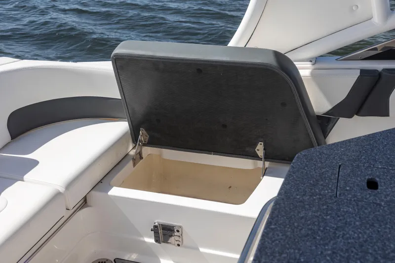 Slide: The Image of 2022 Chaparral 300 OSX boat with open storage compartment on deck. - 15