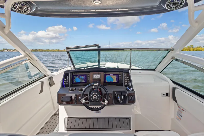 Slide: The Image of 2022 Chaparral 300 OSX boat helm with modern controls and navigation screens. - 17