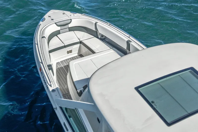 Slide: The Image of 2022 Chaparral 300 OSX boat on blue water, featuring spacious seating and sleek design. - 2