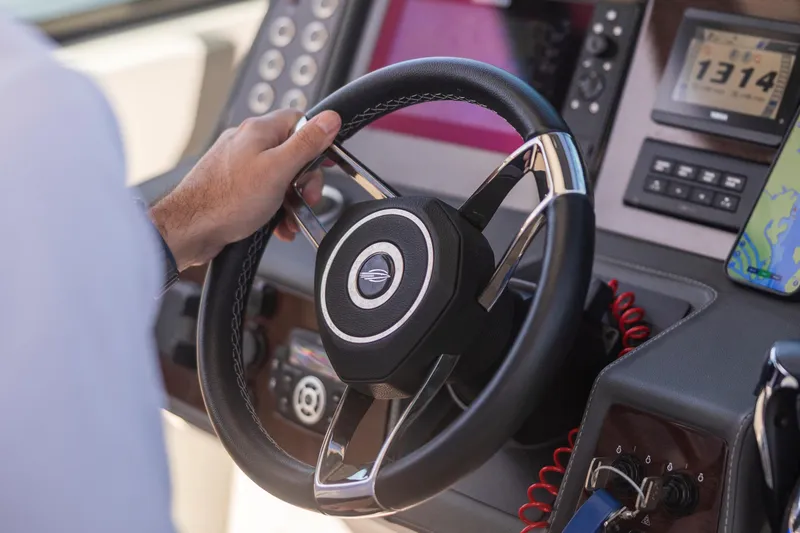 Slide: The Image of Steering wheel of 2022 Chaparral 300 OSX boat with dashboard controls and navigation display. - 5