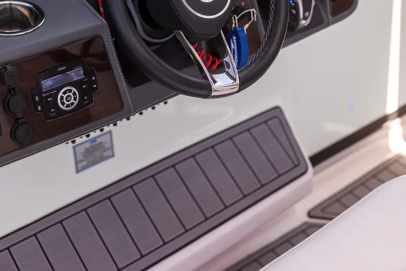 Slide: The Image of 2022 Chaparral 300 OSX boat dashboard with steering wheel and control panel. - 6