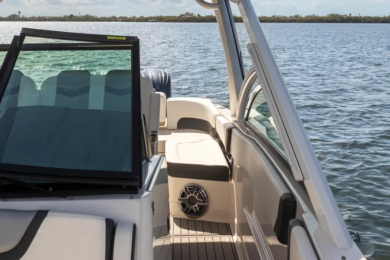 Slide: The Image of 2022 Chaparral 300 OSX boat interior with seating, on a calm lake. - 7