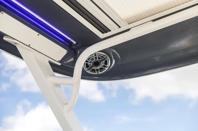 Slide: The Image of 2022 Chaparral 300 OSX boat speaker and lighting detail against blue sky. - 8