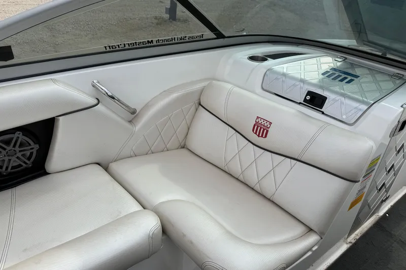 Slide: The Image of 2012 MasterCraft X2 boat interior with white leather seating and speaker. - 11