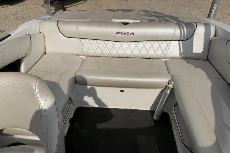 Slide: The Image of 2012 MasterCraft X2 boat interior with beige seating and diamond stitching. - 12
