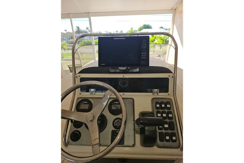 Slide: The Image of Sterling 220XS 2012 boat dashboard with steering wheel and navigation controls. - 10