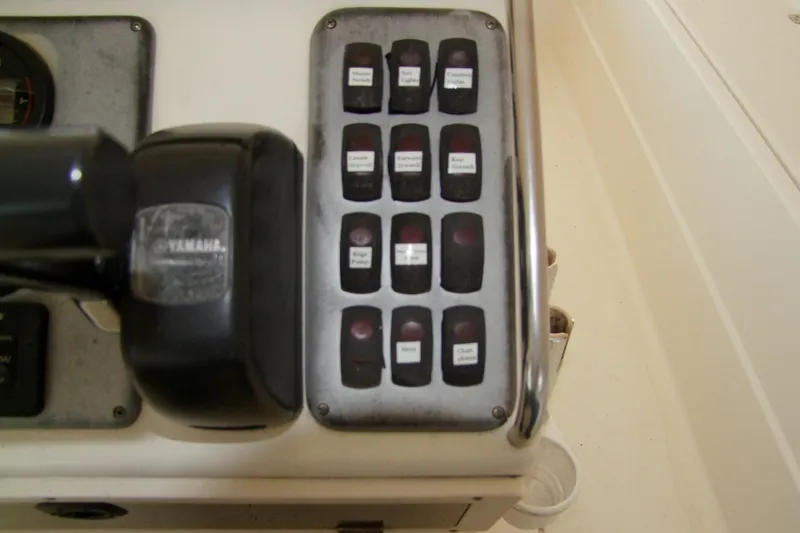 Slide: The Image of Control panel of a 2012 Sterling 220XS boat with labeled switches. - 13