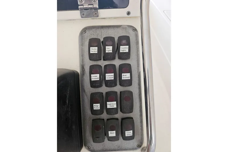 Slide: The Image of Control panel of a 2012 Sterling 220XS boat with labeled switches. - 19