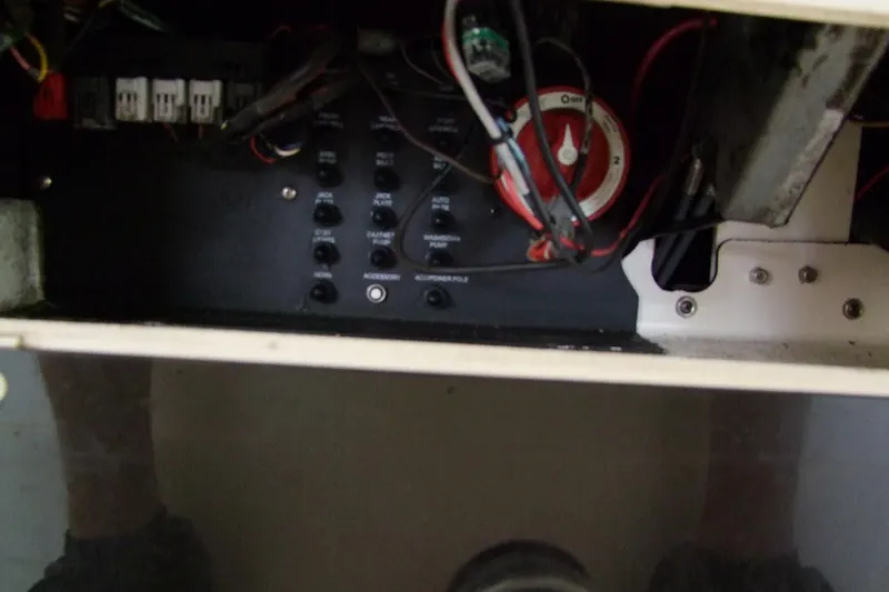 Slide: The Image of Electrical panel inside a 2012 Sterling 220XS boat, featuring switches and wiring. - 23