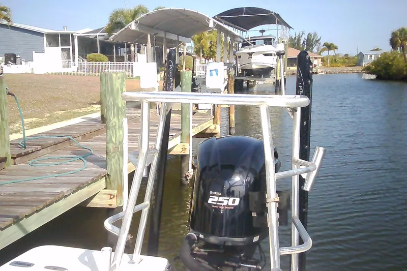 Slide: The Image of 2012 Sterling 220XS boat docked with Yamaha 250 engine, near waterfront homes. - 29
