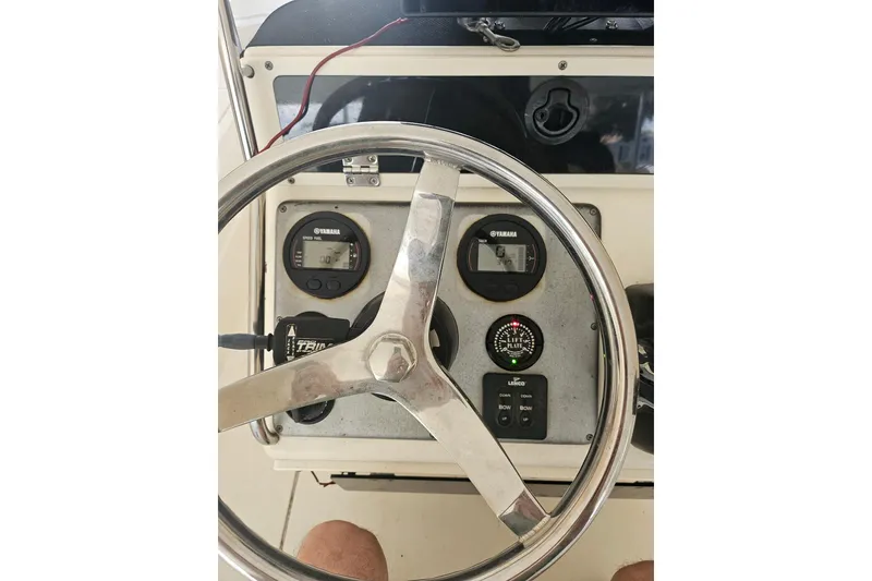 Slide: The Image of Steering wheel and dashboard of 2012 Sterling 220XS boat with Yamaha gauges. - 3