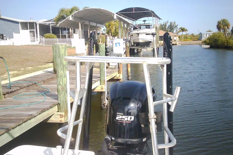 Slide: The Image of 2012 Sterling 220XS boat with Yamaha 250 engine docked by waterfront homes. - 31