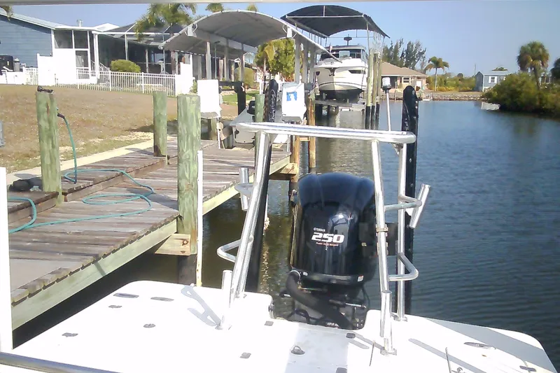 Slide: The Image of 2012 Sterling 220XS boat docked by waterfront homes, featuring a Yamaha 250 engine. - 33