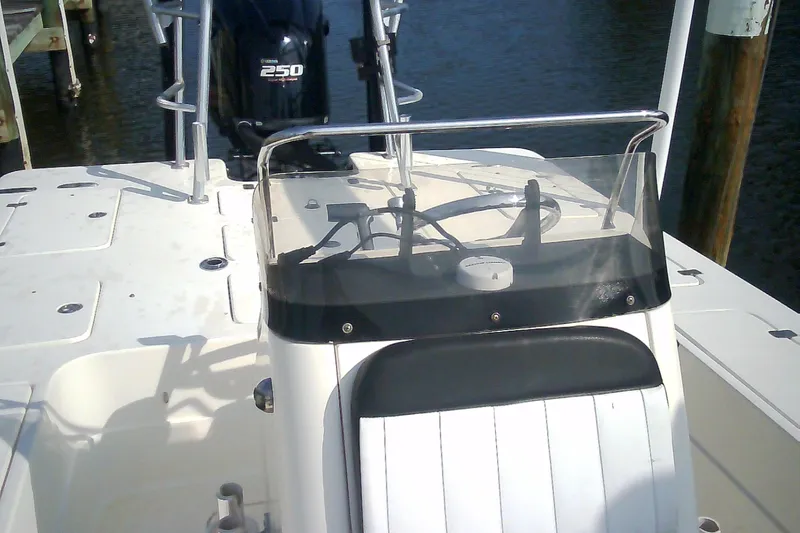 Slide: The Image of 2012 Sterling 220XS boat with Yamaha 250 engine, docked on calm water. - 36