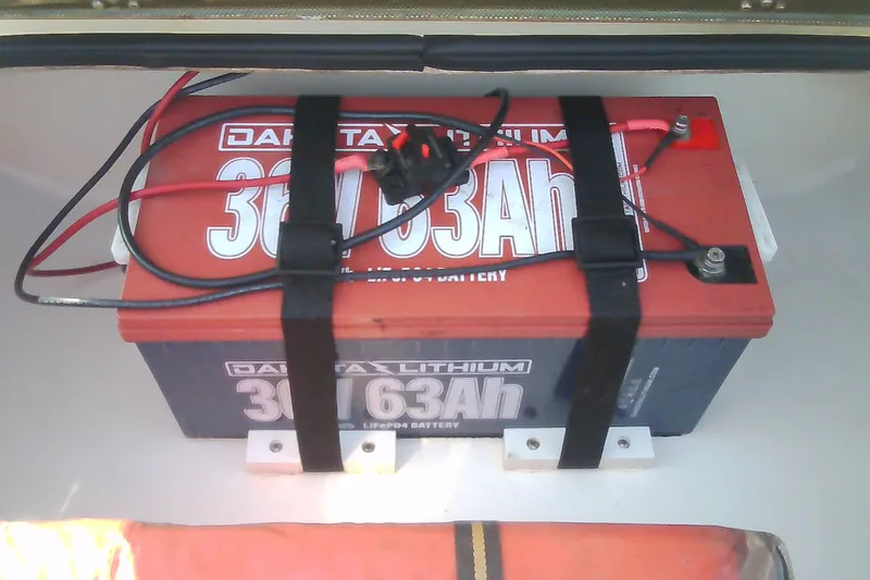 Slide: The Image of Lithium battery in 2012 Sterling 220XS boat, secured with straps. - 38