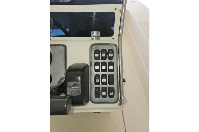 Slide: The Image of Control panel of a 2012 Sterling 220XS boat with Yamaha throttle and switches. - 4