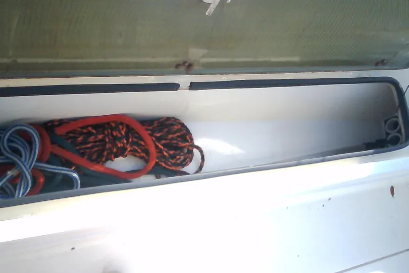Slide: The Image of Storage compartment of 2012 Sterling 220XS boat with ropes inside. - 41