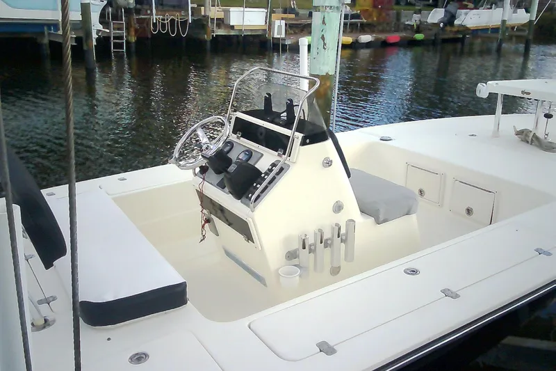 Slide: The Image of 2012 Sterling 220XS boat interior with steering console, docked by the water. - 47