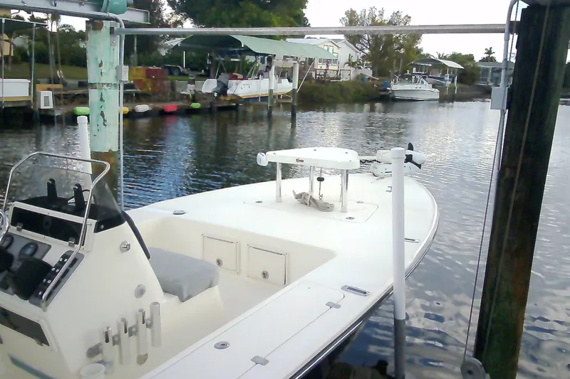 Slide: The Image of 2012 Sterling 220XS boat docked in a serene waterfront setting. - 48