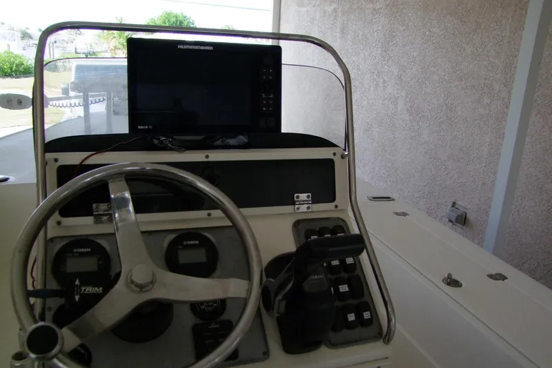 Slide: The Image of 2012 Sterling 220XS boat dashboard with steering wheel and Humminbird Solix 10 display. - 8