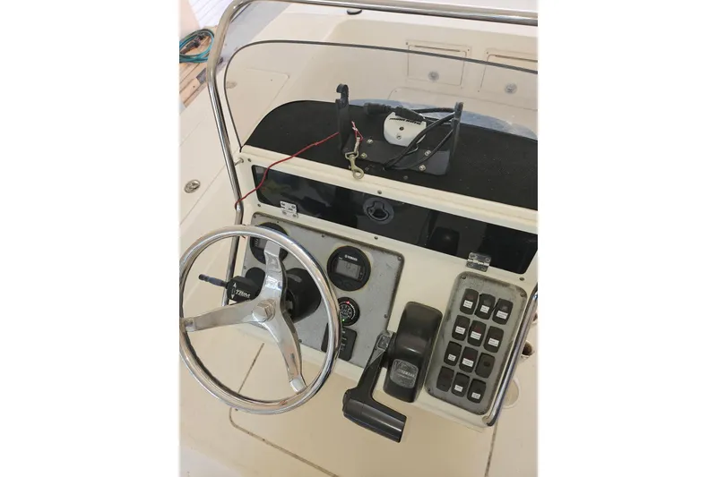 Slide: The Image of Sterling 220XS 2012 boat dashboard with steering wheel and control panel. - 9