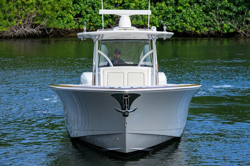 Slide: The Image of 2021 Valhalla Boatworks V-41 cruising on a serene waterway, surrounded by lush greenery. - 2