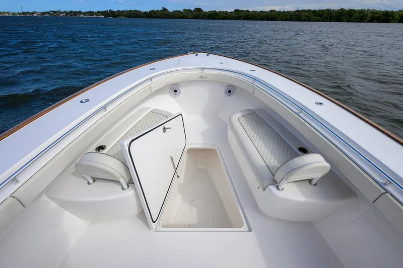 Slide: The Image of 2021 Valhalla Boatworks V-41 bow seating with open storage compartment on calm water. - 21