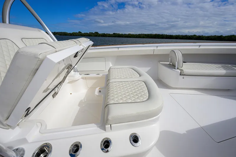 Slide: The Image of 2021 Valhalla Boatworks V-41 interior with white cushioned seating and storage compartment. - 26