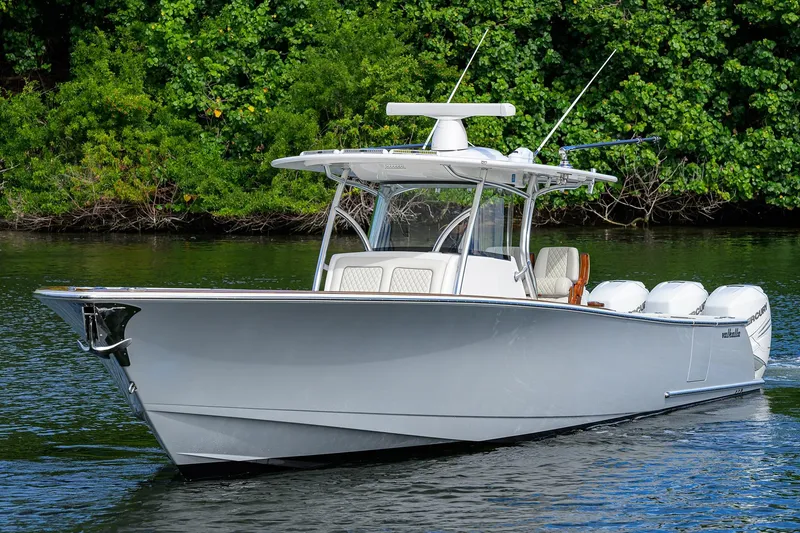 Slide: The Image of 2021 Valhalla Boatworks V-41 cruising on a serene waterway, surrounded by lush greenery. - 3