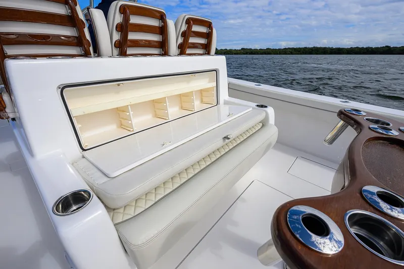 Slide: The Image of 2021 Valhalla Boatworks V-41 interior with seating and storage, on a calm water backdrop. - 39