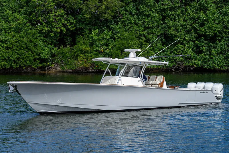 Slide: The Image of 2021 Valhalla Boatworks V-41 cruising on a serene waterway, surrounded by lush greenery. - 4