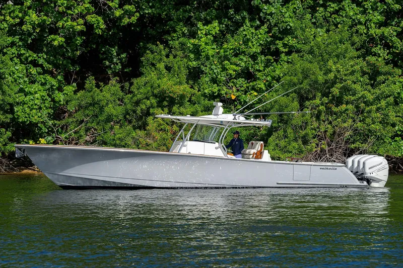 Slide: The Image of 2021 Valhalla Boatworks V-41 cruising on a calm lake with lush green backdrop. - 5