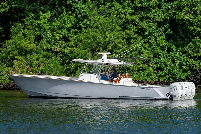 Slide: The Image of 2021 Valhalla Boatworks V-41 on water, surrounded by lush greenery. - 6