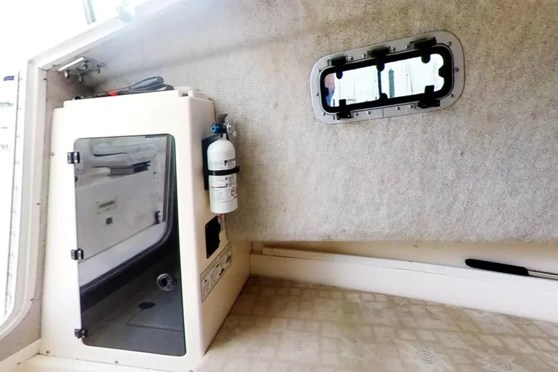 Slide: The Image of Interior of 2005 Shamrock 246 Adventurer boat with fire extinguisher and window. - 10