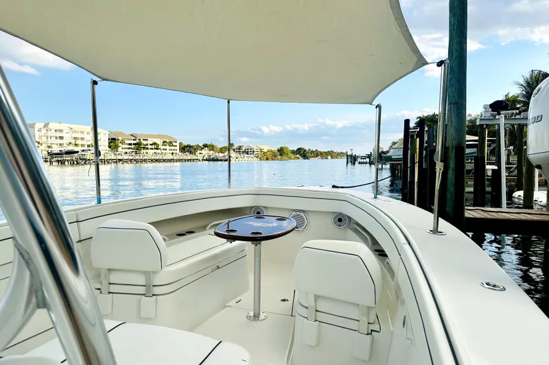 Slide: The Image of 2015 Jupiter 38 FS boat with canopy, docked in a scenic waterfront location. - 10