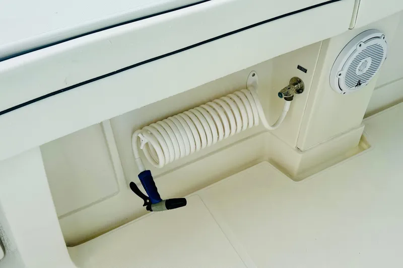 Slide: The Image of Coiled hose and speaker on 2015 Jupiter 38 FS boat deck. - 17