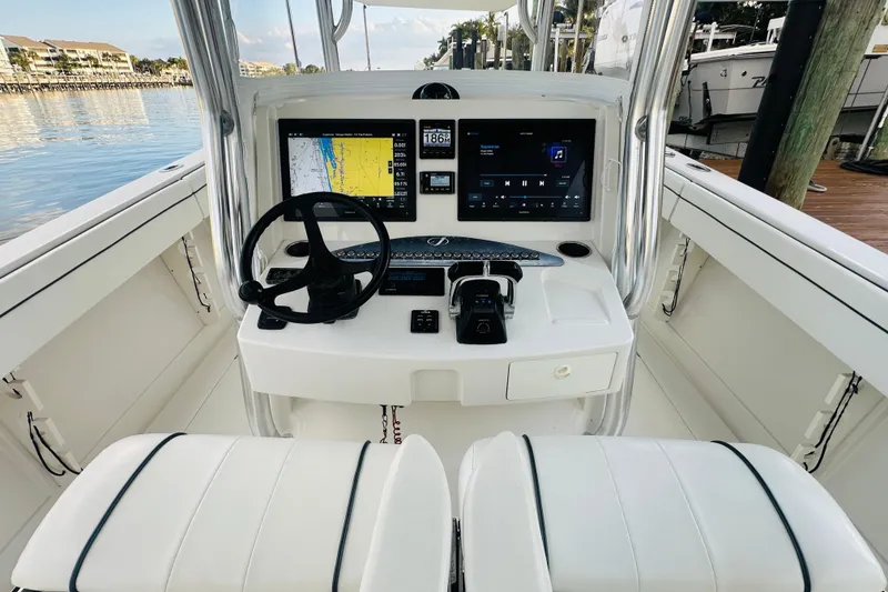 Slide: The Image of 2015 Jupiter 38 FS boat cockpit with dual screens and steering wheel. - 19