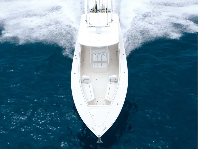 Slide: The Image of 2015 Jupiter 38 FS boat on calm water, featuring dual engines and custom graphics. - 2